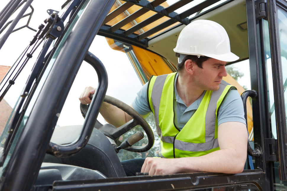 Construction worker driving vehicle