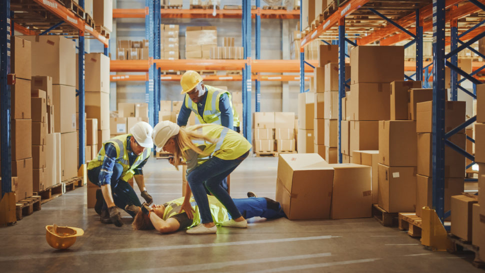 Fallen worker is surrounded by coworkers