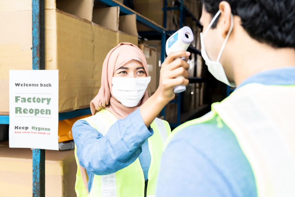 Warehouse Worker Takes Temperature