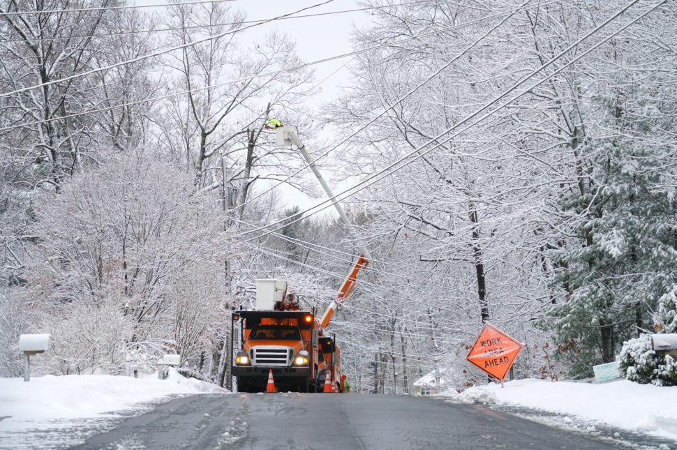 Workers fix powerlines in snow