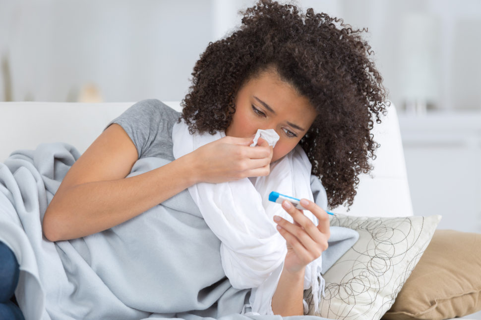 Woman lays in bed sick