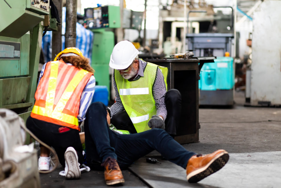 workers give their coworker first aid