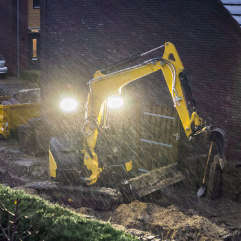 Excavator working during a storm